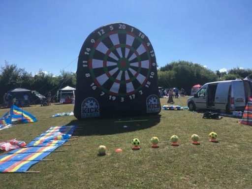 An inflatable kick darts game